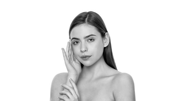 lady portrait isolated on white. daily habit and personal care. skincare beauty. hand at face. smooth and soft female skin. woman touch face. young girl with bare shoulders. - Photo, Image