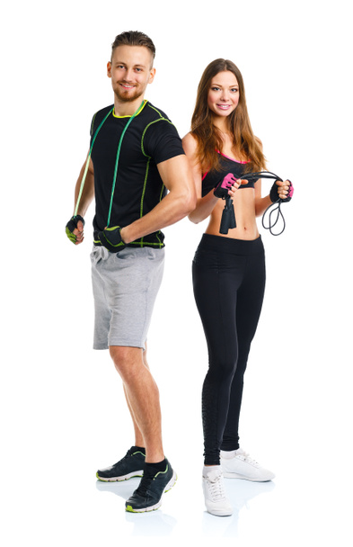 Happy athletic couple - man and woman with with ropes on the whi - Photo, Image