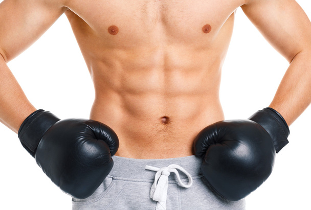 Athletic attractive man wearing boxing gloves on the white - Photo, Image