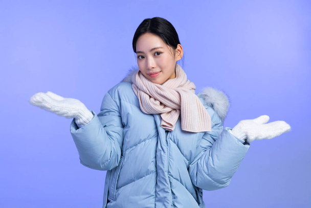 beautiful young Korean Asian woman portrait studio photo in winter skin beauty and cosmetics concept, smiling with hand motion - Φωτογραφία, εικόνα