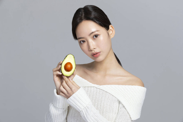 beautiful young Korean Asian woman portrait studio photo in winter skin beauty and cosmetics concept, hand motion - Fotografie, Obrázek