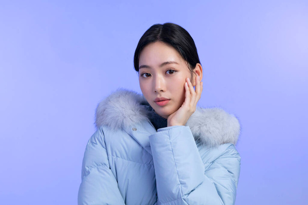 beautiful young Korean Asian woman portrait studio photo in winter skin beauty and cosmetics concept, weared padded - 写真・画像