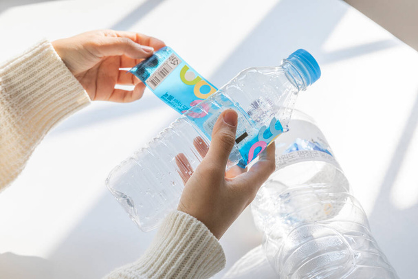 eco friendly habits hand gesture, remove the bottle label - Foto, Imagem