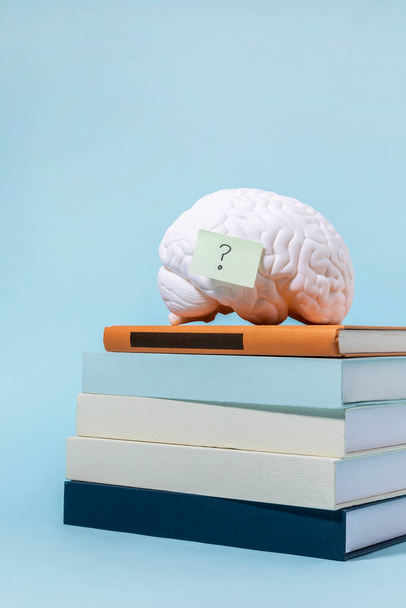 brain health and dementia series_stacked books and brain miniature - Fotoğraf, Görsel