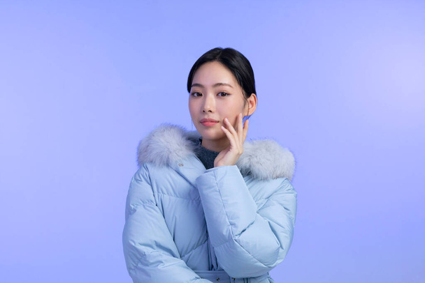 beautiful young Korean Asian woman portrait studio photo in winter skin beauty and cosmetics concept, weared padded - Zdjęcie, obraz