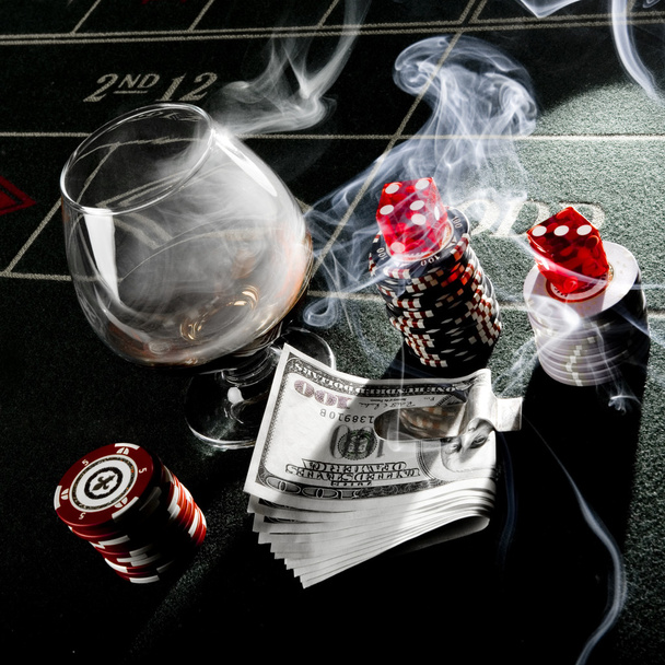 Dice, money, drink and chips on dice table at casino - Photo, Image