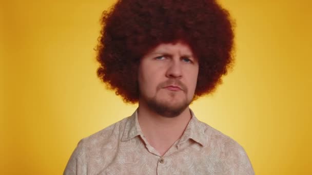 Displeased upset bearded man with afro hairstyle reacting to unpleasant awful idea, dissatisfied with bad quality, wave hand, shake head No, dismiss idea, dont like proposal. Guy on yellow background - Footage, Video
