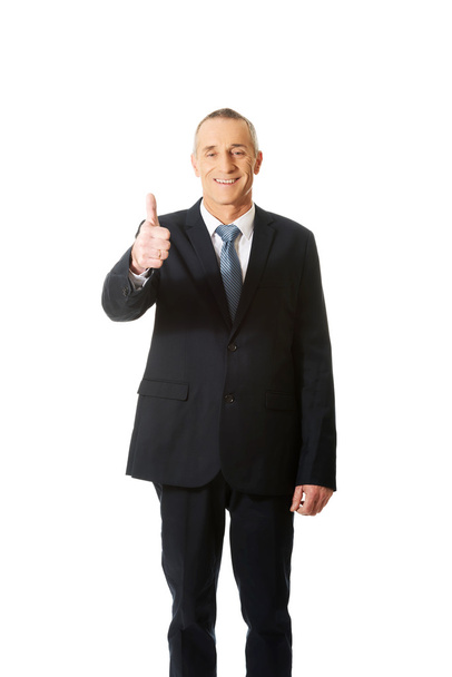 Businessman gesturing thumb up sign - 写真・画像
