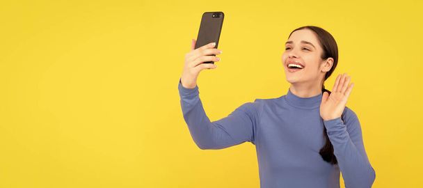 Woman isolated face portrait, banner with copy space. happy girl gesturing hello to on smartphone while video call, vlog - Foto, immagini