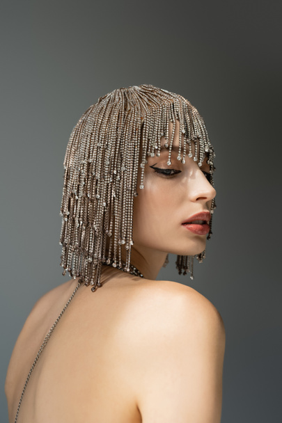 portrait of young woman with metallic jewelry headwear posing isolated on grey  - Foto, afbeelding