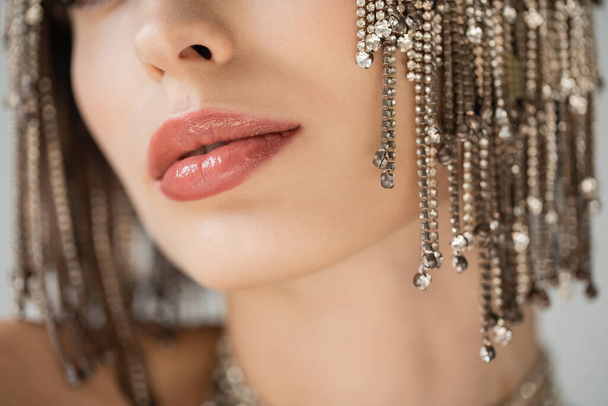 Cropped view of young woman with makeup and jewelry headwear isolated on grey  - Foto, afbeelding