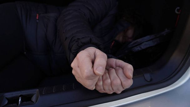 the bound hands of the person lying in the trunk                    - Photo, Image