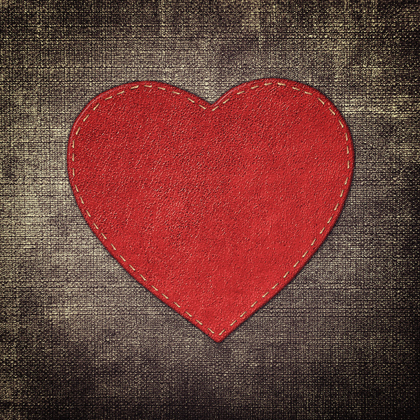 red leather heart on fabric in grunge style - Φωτογραφία, εικόνα
