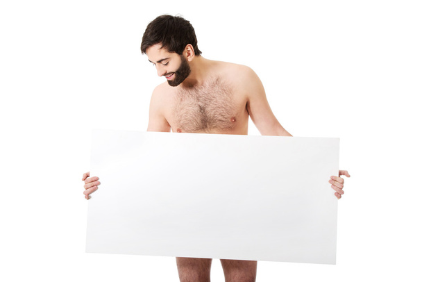 Shirtless man holding empty banner. - Valokuva, kuva