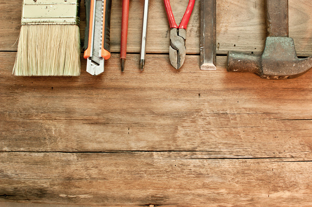 Various tools on a wooden floor. - 写真・画像