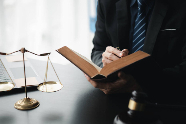 Lawyers read legal books defend their clients' cases, the lawyer concept assumes that the defendant defends the client in order to win the case or gain the greatest benefit in accordance with the law. - Photo, Image
