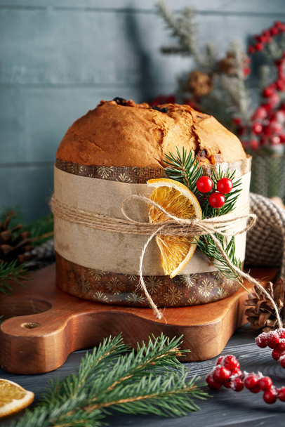 Board with tasty Panettone and Christmas decor on dark table, closeup - Photo, Image
