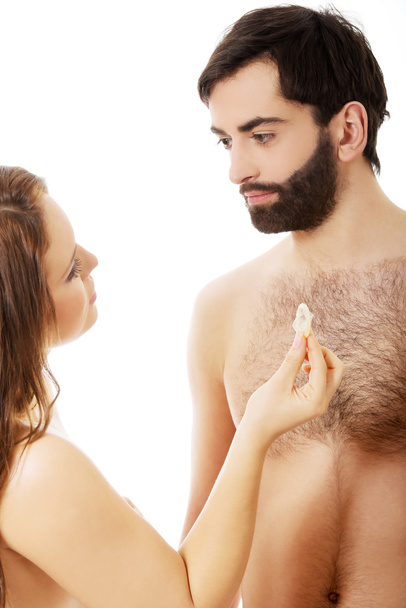 Woman giving a condom to her man. - Fotografie, Obrázek