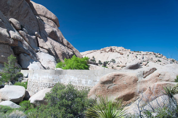 Barker Dam and rock formations within the arid desert ecosystem on the barker dam Trail within Joshua Tree national Park in Joshua Tree California.   - Fotó, kép