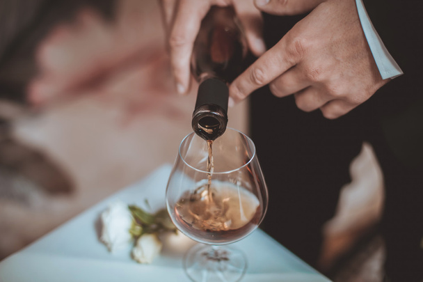 Hands  pouring glass of wine - Foto, Imagen
