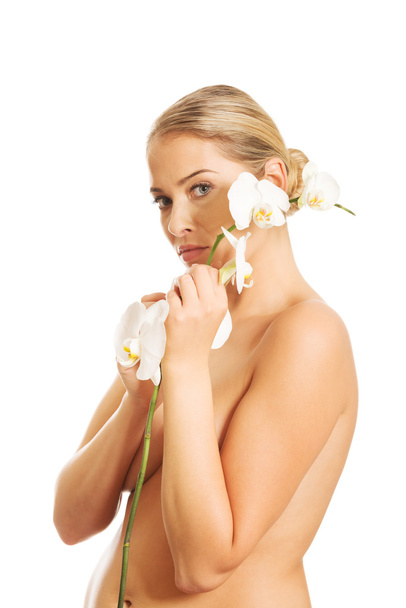 Woman with an orchid flower - Foto, Bild