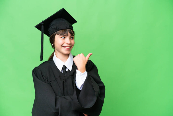 Little university girl over isolated background pointing to the side to present a product - Photo, Image