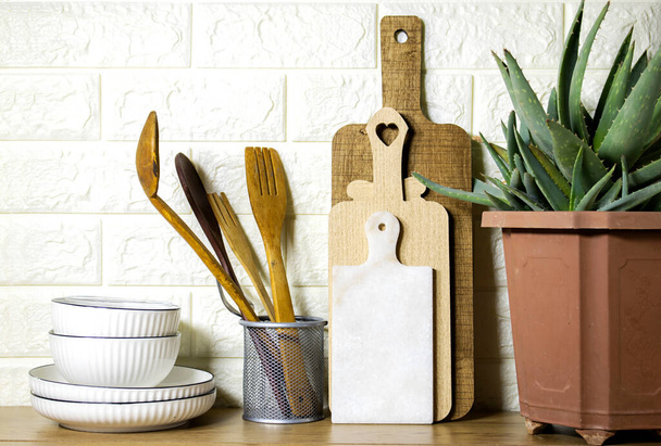 Kitchen utensils background and houseplant aloe vera, home kitchen decor concept, front view - Photo, Image