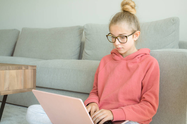 Komoly lány használja laptop ellenőrzése e-mail hírek online ül a kanapén, keres barátokat az interneten szociális hálózatok, vagy dolgozik a számítógép, blog írása, tanul otthon. - Fotó, kép