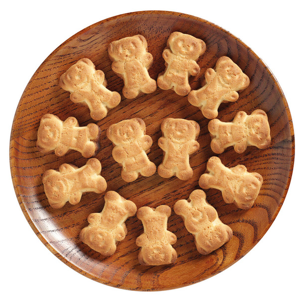Bärenförmige Kekse in Holzteller isoliert auf weißem Hintergrund, Ansicht von oben - Foto, Bild
