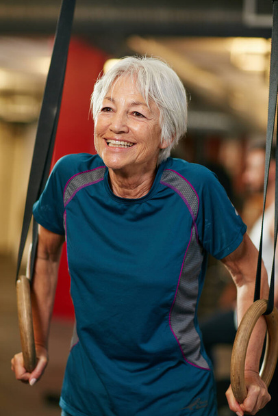 Die Geschäfte sind immer noch so lebhaft wie eh und je. eine Seniorin, die im Fitnessstudio trainiert - Foto, Bild