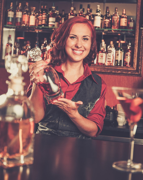 Redhead barmaid with bottle - Photo, Image