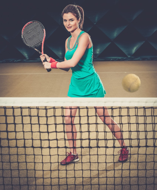 Woman playing tennis indoors - Фото, зображення