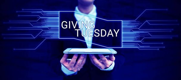 Рука пише підпис Giving Tuesday, Internet Concept international day of charitable giving Hashtag activism - Фото, зображення