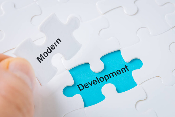 modern development, puzzle revealing text, business concept - Photo, Image