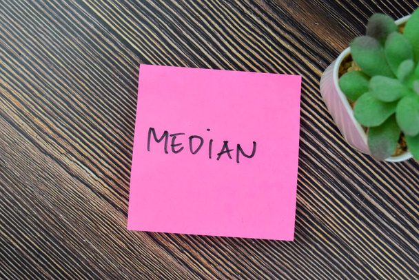 Concept of Median write on sticky notes isolated on Wooden Table. - Foto, Imagen