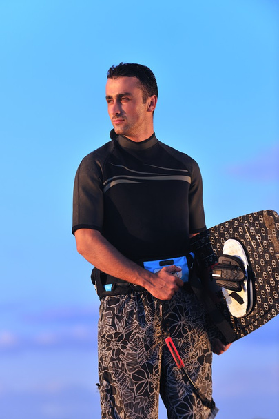 Portrait of a young kitsurf man at beach on sunset - Fotoğraf, Görsel