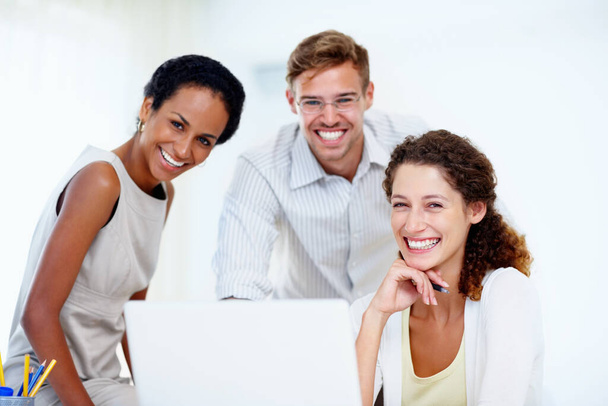 Business people using laptop. Portrait of three business people sitting at table with laptop and smiling - Photo, Image
