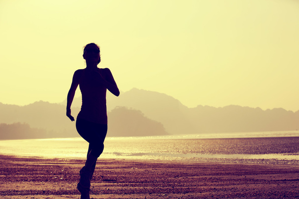 Woman jogging at sunrise - Photo, Image