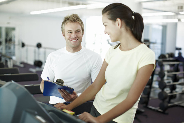 Youre doing great. an attractive young woman working out with her personal trainer - Photo, Image