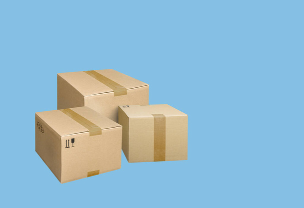 Closed cardboard boxes isolated on blue background - Photo, Image