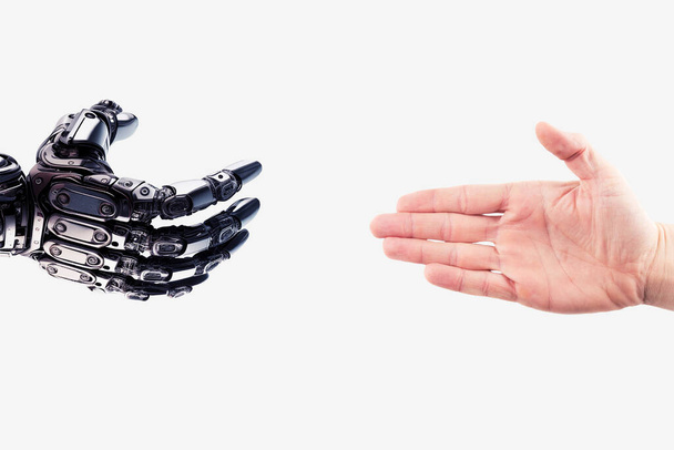 Robot hand reaches out to the human hand. Handshake of a cyborg and a man. Technology concept. Friendship between a robot and a human - Foto, imagen