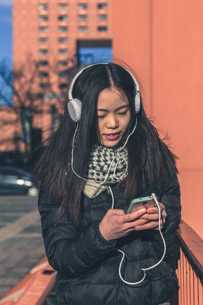 Young beautiful Chinese girl with headphones - Photo, Image