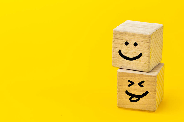 positive thinking, creative concept, hand painted facial expression on wooden blocks, yellow background, copy space, smiling faces, self esteem, good emotions - Photo, Image