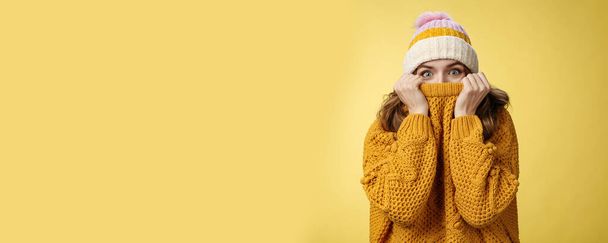 Lifestyle. Charming playful charismatic girl hiding face pull sweater collar nose widen eyes surprised happy fool around having fun enjoying winter vacation mountains escape cold wearing warm clothes. - Photo, Image