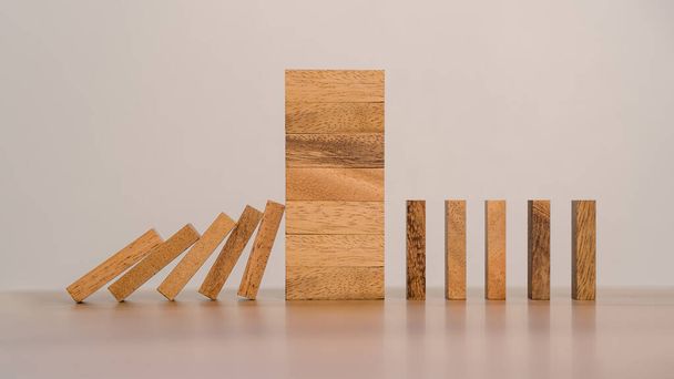 Business Risks and Strategies. Stopping Wood Block Domino. Business Crisis Impact or hedging concept, Prevention and development towards security. - Photo, Image