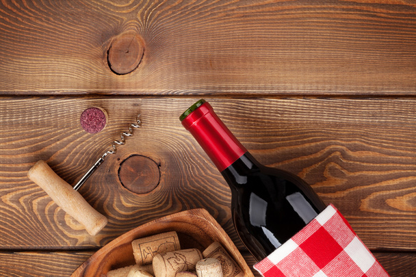 Red wine bottle, bowl with corks and corkscrew - Photo, Image