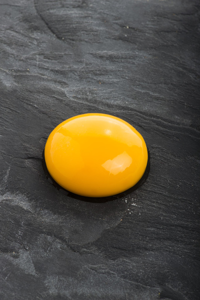 Raw egg close-up on black background - Foto, Bild