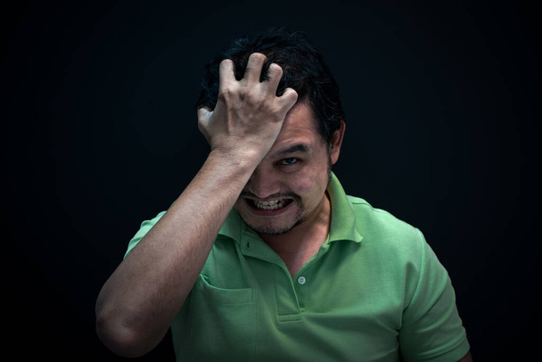 Asian man 40s strain have a anger unhappy gesture with stressed and problems concept on black background dark style - Photo, Image