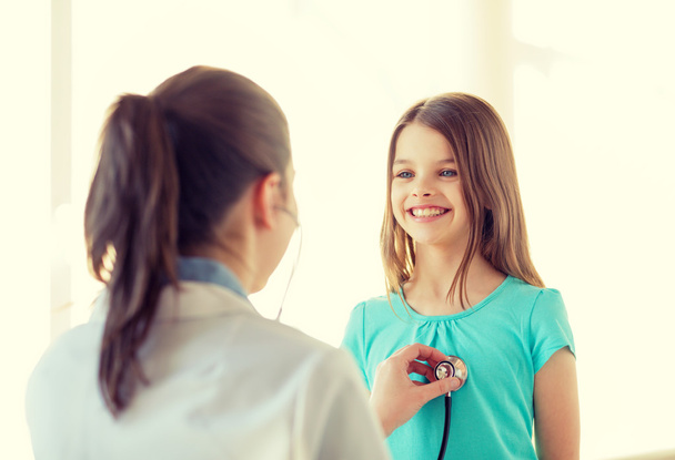 female doctor with stethoscope listening to child - Фото, изображение