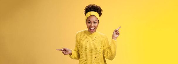 Energized active charismatic african-american woman afro hairstyle in sweater headband screaming fascinated enthusiastic pointing left right impressed variaty awesome choices, picking products. - Photo, Image